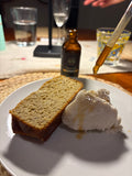 Dropperful of chamomile extract added to ice cream and banana bread on a dinner table.