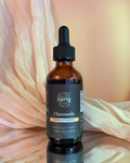 Bottle of chamomile herbal supplement with dropper on a soft fabric background