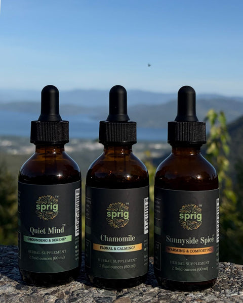 Bottle of Quiet Mind, Chamomile Extract, and Sunnyside Spice on a ledge.