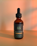 Sprig's Sunnyside Spice Herbal Extract Bottle 2oz on a warm golden background.